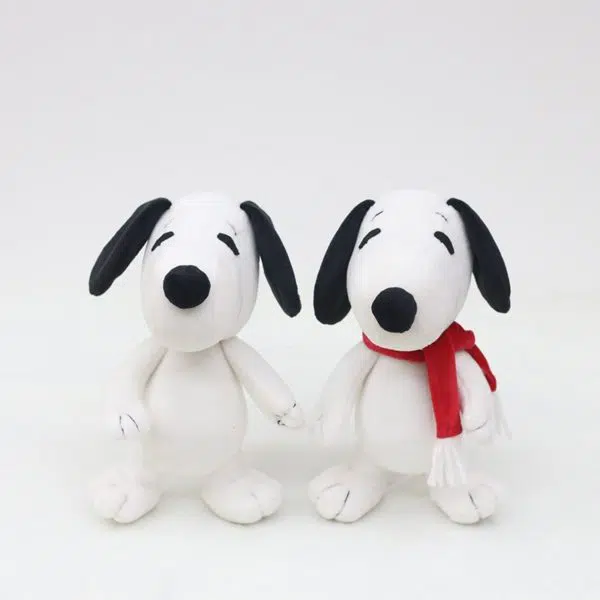 Deux chiens en peluche de dessin animé Kawaii un avec une écharpe rouge et un fond blanc