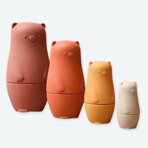 Ensemble de jouets montessori pour bébé en forme d'ours à différents coloris et un fond marron