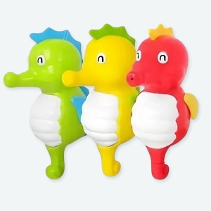Jouet de bain cheval de mer pour bébé à plusieurs coloris un rouge, un jaune et un vert avec un fond blanc.
