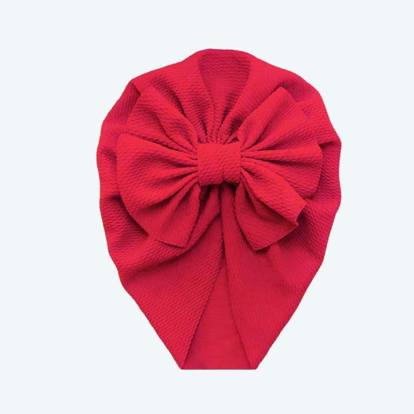 turban pour bébé rouge avec un nœud posé à plat