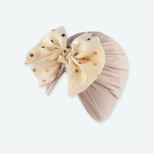 Turban à noeud brillant pour bébé fille sur fond nbleu clair